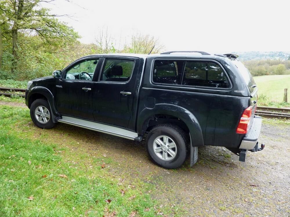 A premium SUV parked on a scenic countryside road, ready for a road trip